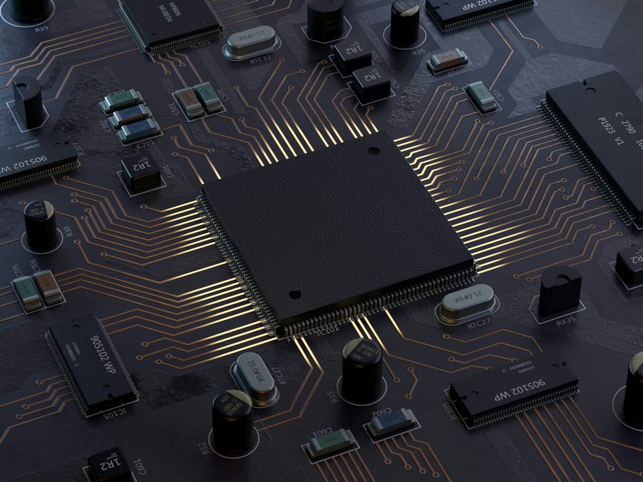 Close-up of a microcontroller and surrounding components on a circuit board representing embedded firmware and software development